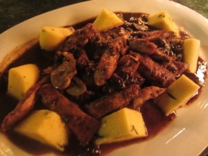 The House Specialty: Porcini Crusted Chicken: prepared in a sun-dried cherry-port wine mushroom sauce with   grana padana parmesan and fresh basil polenta 